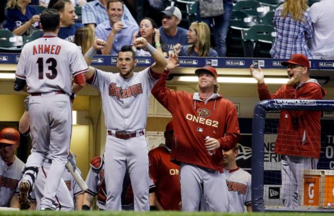 Arizona Diamondbacks' Nick Ahmed (13) is congratulated after hitting a home run during the eighth inning of a baseball game against the Milwaukee Brewers on Friday, May 29, 2015, in Milwaukee. (AP Photo/Morry Gash)