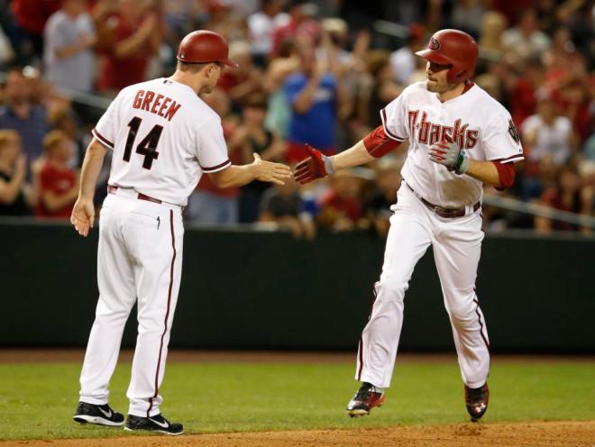Arizona Diamondbacks A.J. Pollock, right, celebrates with third base coach Andy Green in the seventh inning after hitting a two-run home run against the Atlanta Braves during a baseball game, Tuesday, June 2, 2015, in Phoenix. (AP Photo/Rick Scuteri)