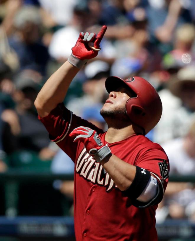 Arizona Diamondbacks' Welington Castillo points skyward as he heads in on his home run against the Seattle Mariners in the fourth inning of a baseball game Wednesday, July 29, 2015, in Seattle. (AP Photo/Elaine Thompson)