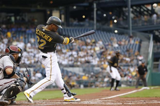 Pittsburgh Pirates' Andrew McCutchen (22) hits to Arizona Diamondbacks left fielder David Peralta to drive in Gregory Polanco from third with a sacrifice in the first inning of a baseball game, Tuesday, Aug. 18, 2015, in Pittsburgh. (AP Photo/Keith Srakocic)