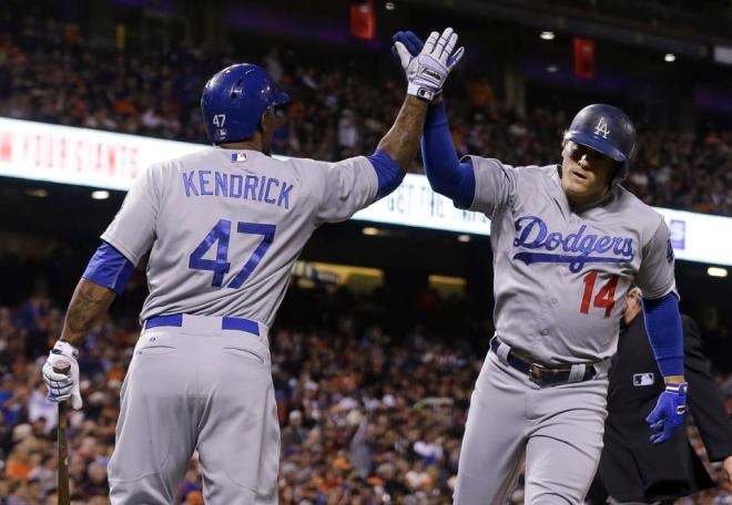 Los Angeles Dodgers' Enrique Hernandez (14) celebrates after hitting a solo home run with Howie Kendrick (47) against the San Francisco Giants during the third inning of a baseball game in San Francisco, Tuesday, Sept. 29, 2015. (AP Photo/Jeff Chiu)