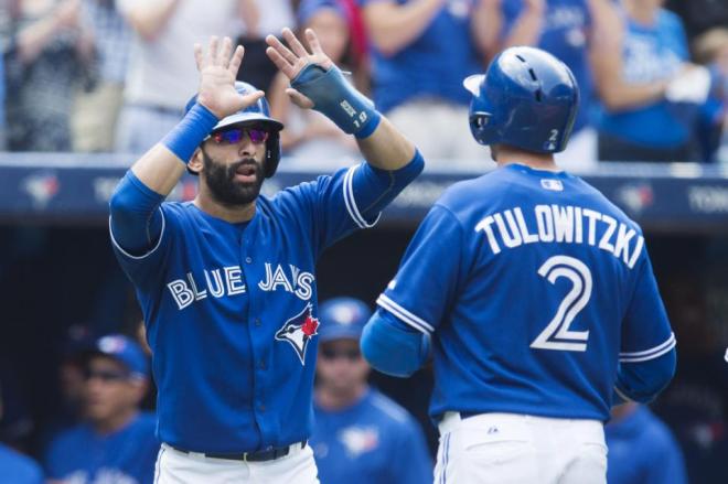 Toronto Blue Jays Jose Bautista, left, and Troy Tulowitzki celebrate Tulowitzki's two-run home run during third-inning baseball game action against the Baltimore Orioles in Toronto, Sunday, Sept. 6, 2015. (Darren Calabrese/The Canadian Press via AP) MANDATORY CREDIT
