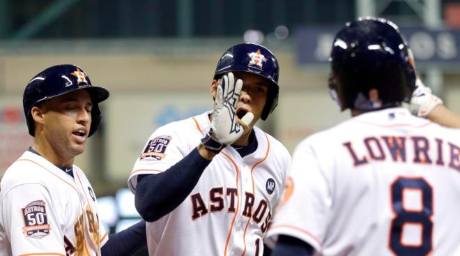 Houston Astros' Carlos Correa (1) celebrates his two-run home run with Jed Lowrie (8) and George Springer, left, during the third inning of a baseball game against the Los Angeles Angels, Monday, Sept. 21, 2015, in Houston. Springer scored on Correa's home run. (AP Photo/David J. Phillip)