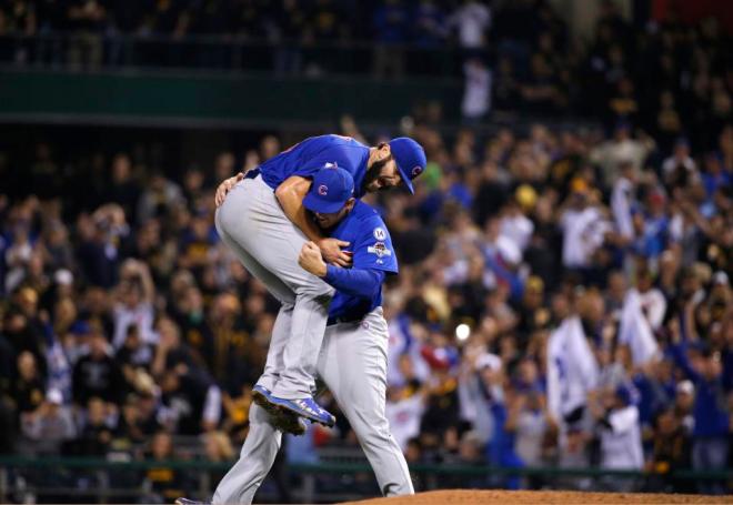 Chicago Cubs first baseman Anthony Rizzo, right, holds Chicago Cubs starting pitcher Jake Arrieta after they defeated the Pittsburgh Pirates in the National League wild card baseball game 4-0, Wednesday, Oct. 7, 2015, in Pittsburgh. The Cubs advance to play the St. Louis Cardinals in the National League Division Series.(AP Photo/Gene J. Puskar)